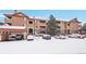 Snow-covered condo building with parking at 8457 S Hoyt Way # 206, Littleton, CO 80128