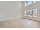 Bright living room featuring high ceilings, large windows, and light wood flooring at 2154 S Gold Bug Way, Aurora, CO 80018