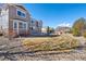 Spacious backyard with a stone patio and mature trees and landscaping at 7765 Yankee Ct, Arvada, CO 80007