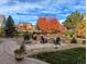 Landscaped backyard with stone walkways, patio, and fire pit area at 7765 Yankee Ct, Arvada, CO 80007