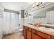 Full bathroom featuring double sinks, a shower/tub combination and ample countertop space at 7765 Yankee Ct, Arvada, CO 80007