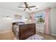 Charming bedroom with a ceiling fan, shiplap accent wall, and a view of the neighborhood at 7765 Yankee Ct, Arvada, CO 80007