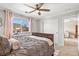 Inviting bedroom with plush carpeting, a ceiling fan, and a window seat overlooking the neighborhood at 7765 Yankee Ct, Arvada, CO 80007