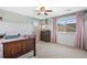 Well-lit bedroom with a ceiling fan, and a window with neighborhood views at 7765 Yankee Ct, Arvada, CO 80007
