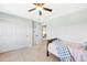 Bright bedroom featuring a ceiling fan and an adjacent closet at 7765 Yankee Ct, Arvada, CO 80007