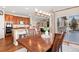 Dining area with a view, hardwood floors, stylish lighting, and a seamless transition to the kitchen at 7765 Yankee Ct, Arvada, CO 80007