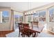 Bright dining area featuring large windows and sliding glass door to outdoor patio at 7765 Yankee Ct, Arvada, CO 80007