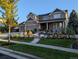 Beautiful two-story home with manicured front yard, stone accents, and a welcoming front porch at 7765 Yankee Ct, Arvada, CO 80007