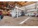 Spacious garage with ample storage, hanging bike rack, work bench and concrete flooring at 7765 Yankee Ct, Arvada, CO 80007