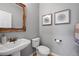 Stylish half bath featuring modern fixtures and decorative wall art at 7765 Yankee Ct, Arvada, CO 80007