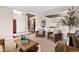 Bright living room with high ceilings, a cozy seating area, and natural light from large windows at 7765 Yankee Ct, Arvada, CO 80007