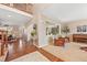 Open-concept living room featuring hardwood floors, large windows, and comfortable seating area at 7765 Yankee Ct, Arvada, CO 80007