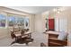 Comfortable living room with large windows, a stylish coffee table, and a welcoming red front door at 7765 Yankee Ct, Arvada, CO 80007