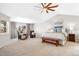 Spacious main bedroom with a ceiling fan, neutral tones, and a seating area near the windows at 7765 Yankee Ct, Arvada, CO 80007