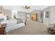 Spacious main bedroom with a ceiling fan, neutral tones, a window, and a view of the hallway at 7765 Yankee Ct, Arvada, CO 80007