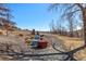 A community playground with colorfully painted wooden logs for children to play on at 7765 Yankee Ct, Arvada, CO 80007