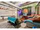 Finished basement area with a pool table, entertainment area, and colorful decor at 3365 S Poppy St, Morrison, CO 80465