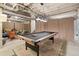 Basement game room featuring a pool table and living area with modern decor at 3365 S Poppy St, Morrison, CO 80465