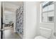 Bathroom featuring a toilet and floral shower curtain, bright interior at 3365 S Poppy St, Morrison, CO 80465