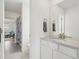 Bright bathroom with a modern vanity, a large mirror, and neutral paint at 3365 S Poppy St, Morrison, CO 80465