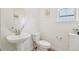 Stylish powder room with pedestal sink, modern fixtures, and elegant finishes at 3365 S Poppy St, Morrison, CO 80465