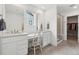 Bright bathroom featuring dual sinks, a vanity area, and a glass-enclosed shower at 3365 S Poppy St, Morrison, CO 80465