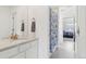 Bright bathroom with a modern vanity, a large mirror, and neutral paint at 3365 S Poppy St, Morrison, CO 80465