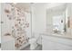 Clean bathroom featuring a sink, toilet, shower, and a stylish floral shower curtain at 3365 S Poppy St, Morrison, CO 80465