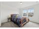 Bright bedroom with a blue floral-themed bed set, two windows, and a view of the outdoors at 3365 S Poppy St, Morrison, CO 80465