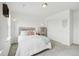 Well-lit bedroom featuring neutral colors, gray carpet, and a minimalist aesthetic at 3365 S Poppy St, Morrison, CO 80465