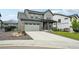 Two-story home with an attached garage and a concrete driveway at 3365 S Poppy St, Morrison, CO 80465