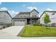 Charming two-story home with a well-manicured lawn and solar panels on the roof at 3365 S Poppy St, Morrison, CO 80465