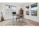 Bright office space with ample natural light boasts hardwood floors, a sit/stand desk and a modern aesthetic at 3365 S Poppy St, Morrison, CO 80465