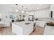 Open concept kitchen with an island and stainless steel appliances, flowing into the living area at 3365 S Poppy St, Morrison, CO 80465