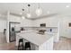 Modern kitchen with white cabinets, stainless steel appliances, and a large island at 3365 S Poppy St, Morrison, CO 80465