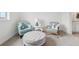 Comfortable living area with modern chairs, a tufted ottoman, and neutral paint at 3365 S Poppy St, Morrison, CO 80465