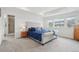 Serene main bedroom with tray ceiling, plush carpet, and large windows offering views at 3365 S Poppy St, Morrison, CO 80465