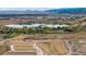 Expansive aerial view showcasing a new construction site overlooking a tranquil lake and mountains at 14422 Pansy Loop, Morrison, CO 80465