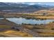 Scenic aerial view of a community with a lake, highways, and mountains in the background at 14422 Pansy Loop, Morrison, CO 80465