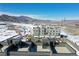 New townhome construction featuring rooftop patios and mountain views in a scenic, snow-covered setting at 14422 Pansy Loop, Morrison, CO 80465