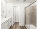 Bathroom with modern vanity, grey tile shower and wood flooring at 14422 Pansy Loop, Morrison, CO 80465