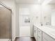 Bathroom with modern vanity, grey tile shower and wood flooring at 14422 Pansy Loop, Morrison, CO 80465