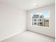 A light filled bedroom with a large window overlooking an exterior building at 14422 Pansy Loop, Morrison, CO 80465