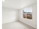 Bright, carpeted bedroom featuring a large window with natural light and neutral wall color at 14422 Pansy Loop, Morrison, CO 80465