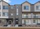 Contemporary townhome exteriors with a mix of siding and brick, offering curb appeal and modern design at 14422 Pansy Loop, Morrison, CO 80465