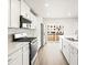 Modern kitchen with white cabinets, stainless steel appliances, and a view of nearby construction at 14422 Pansy Loop, Morrison, CO 80465