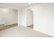 Neutral colored living room with an open door and view of carpeted stairs at 14422 Pansy Loop, Morrison, CO 80465