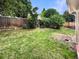 A fully fenced backyard with tree and grass at 14822 E Adriatic Pl, Aurora, CO 80014
