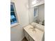 Bathroom features a white vanity with solid countertop and window view at 14822 E Adriatic Pl, Aurora, CO 80014