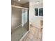 A full bathroom with glass shower door, tile surround and tile floor at 14822 E Adriatic Pl, Aurora, CO 80014